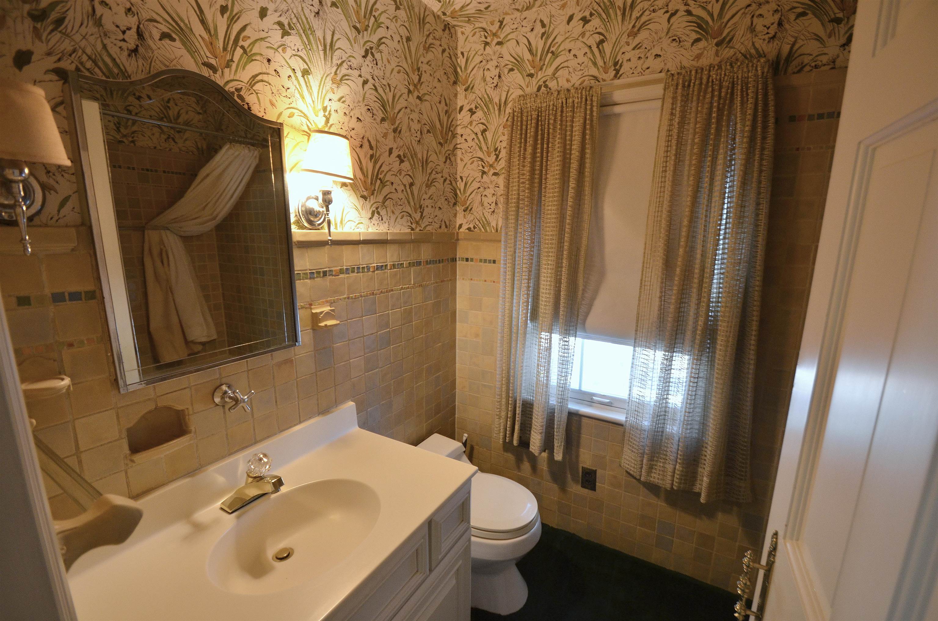 4980 Spring Brook Road Rockford, IL 61114 - Photo 42 of 50 a bathroom with a sink and mirror with toilet
