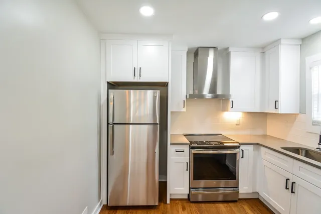 a kitchen with stainless steel appliances a refrigerator stove and microwave