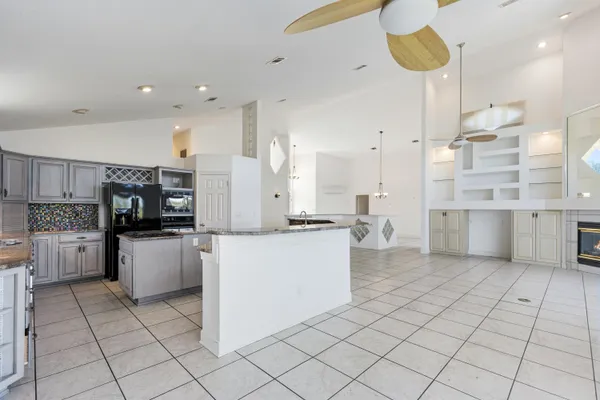 a kitchen with granite countertop a sink stove and cabinets