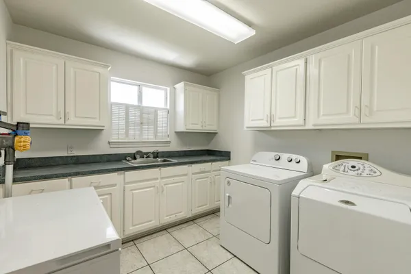 a bathroom with a granite countertop shower and a sink