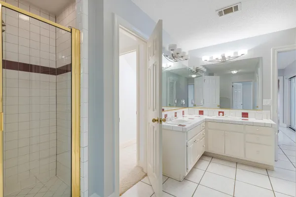 a view of livingroom with fireplace ceiling fan and windows