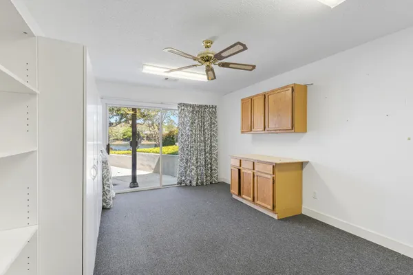a bathroom with a granite countertop sink a toilet and a mirror
