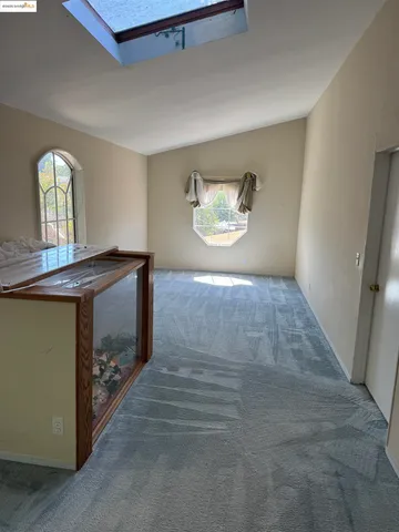 a front view of a house with plants and outdoor seating