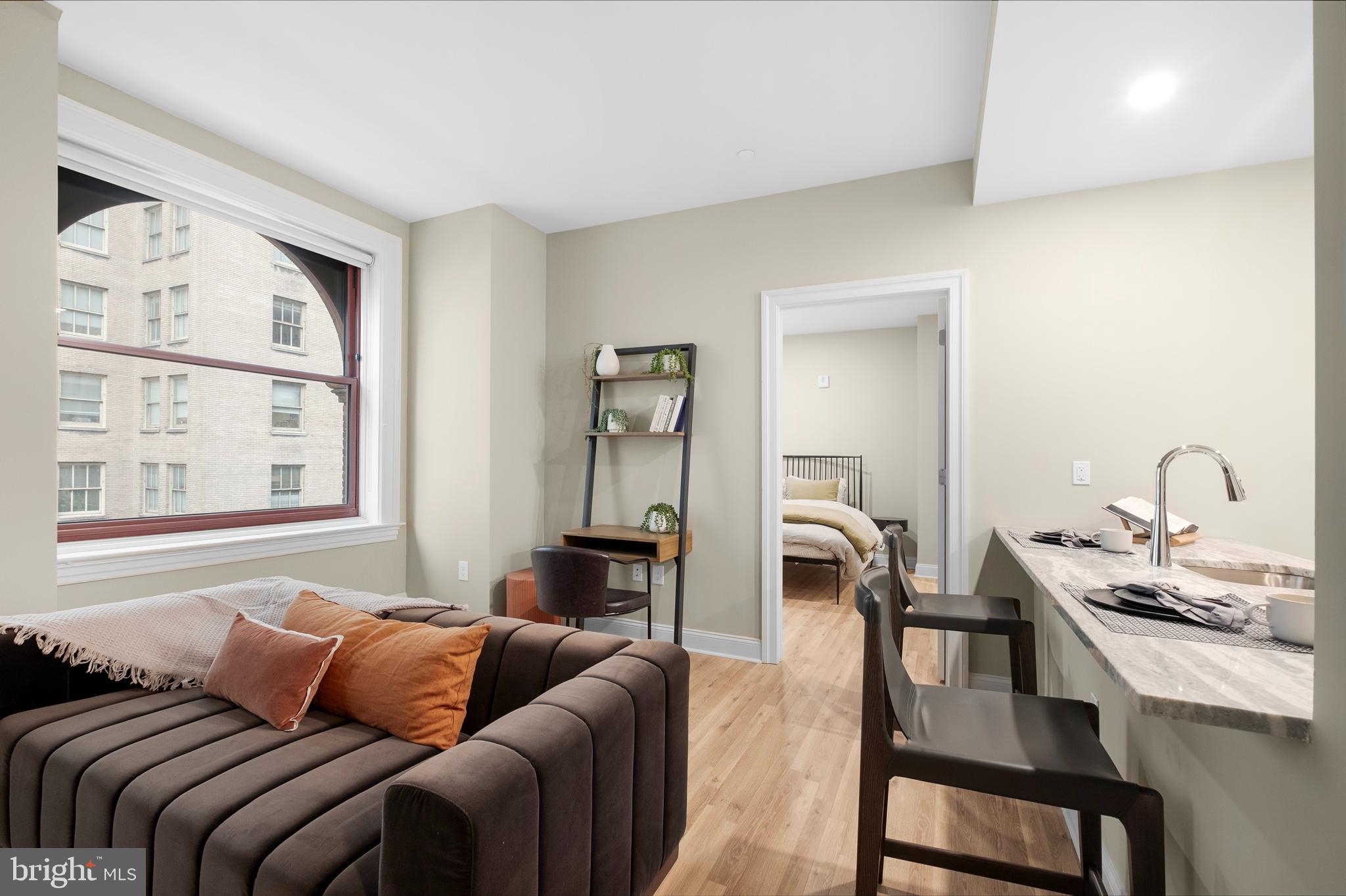 1420-22 Chestnut Street, Unit 806 Philadelphia, PA 19102 - Photo 3 of 35 a bedroom with a bed and a table in it