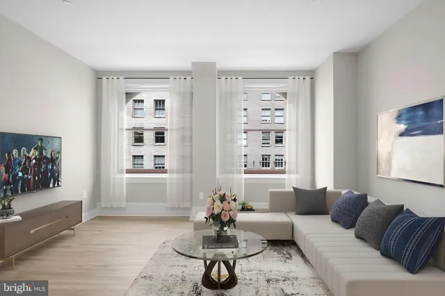 a living room with furniture and a large window