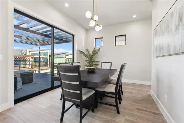 a view of a dining room with furniture wooden floor and a chandelier