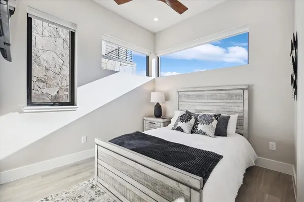 a bedroom with a bed and a painting on the wall
