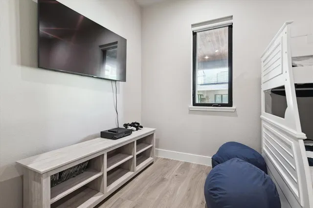 a view of bedroom with a bed and wooden floor