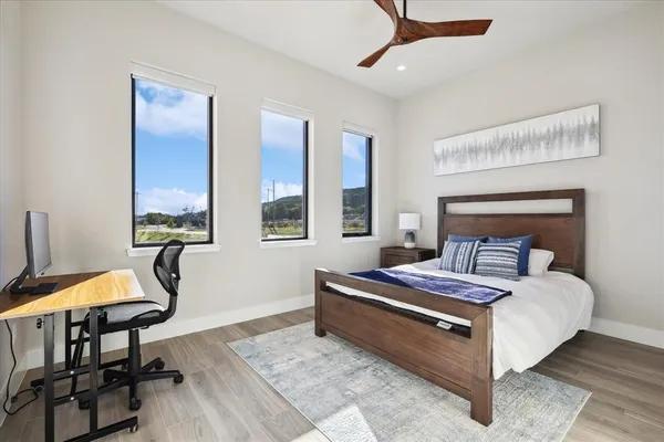 a bedroom with a bed a table and chair