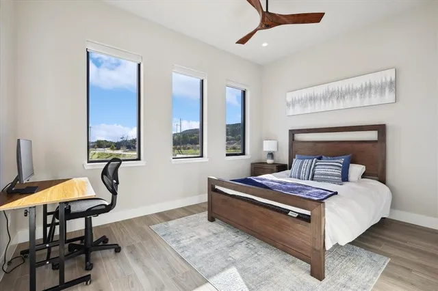 a bedroom with a bed a table and chair