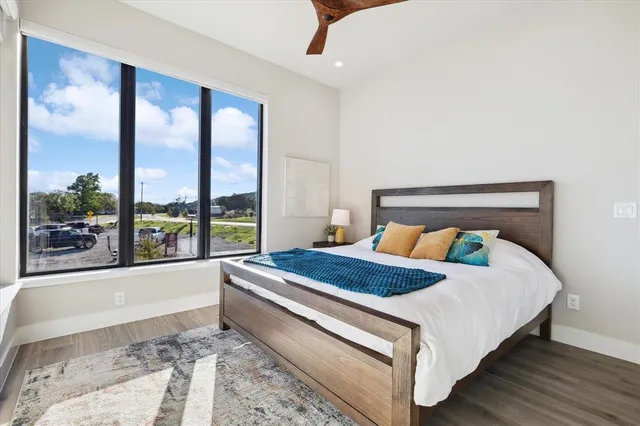 a bed sitting in a bedroom next to a large window