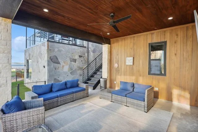 a living room with furniture and a glass door