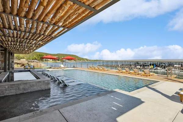 a view of a swimming pool with a lounge chair