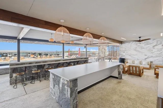 a large white kitchen with a large window