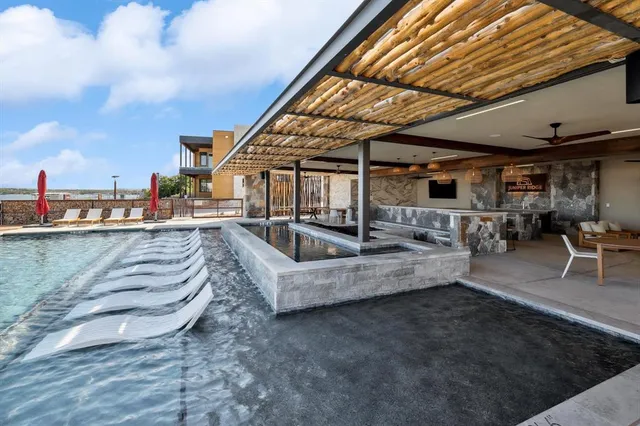 a view of roof deck with table and chairs a barbeque