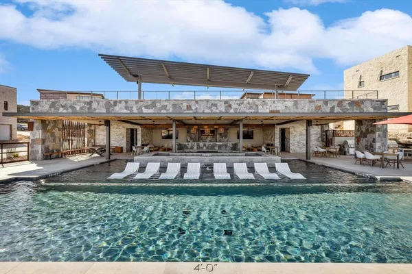 a view of a swimming pool with a yard