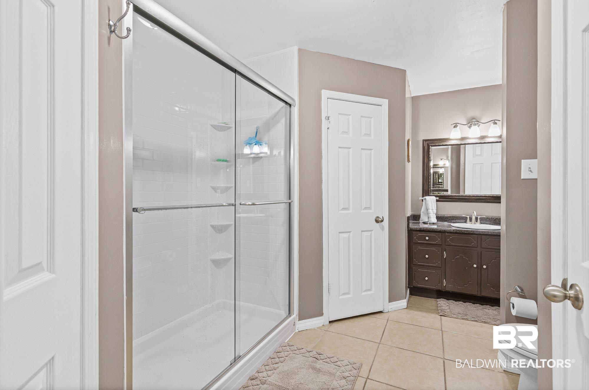 6609 Blakeley Court Mobile, AL 36695 - Photo 21 of 28 Full bath with vanity, light tile patterned floors, and a shower stall