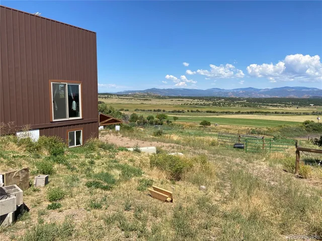 a kitchen with granite countertop a refrigerator and a sink