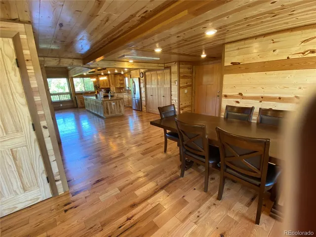 a view of a living room and floor to ceiling window and wooden floor