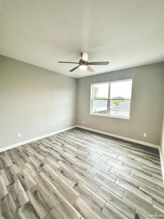 5402 North Crown Point Pharr, TX 78577 - Photo 2 of 19 an empty room with chandelier fan and windows