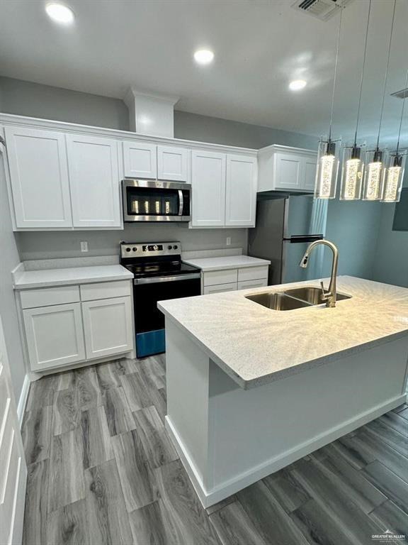5402 North Crown Point Pharr, TX 78577 - Photo 10 of 19 a kitchen with a sink a stove a refrigerator and cabinets