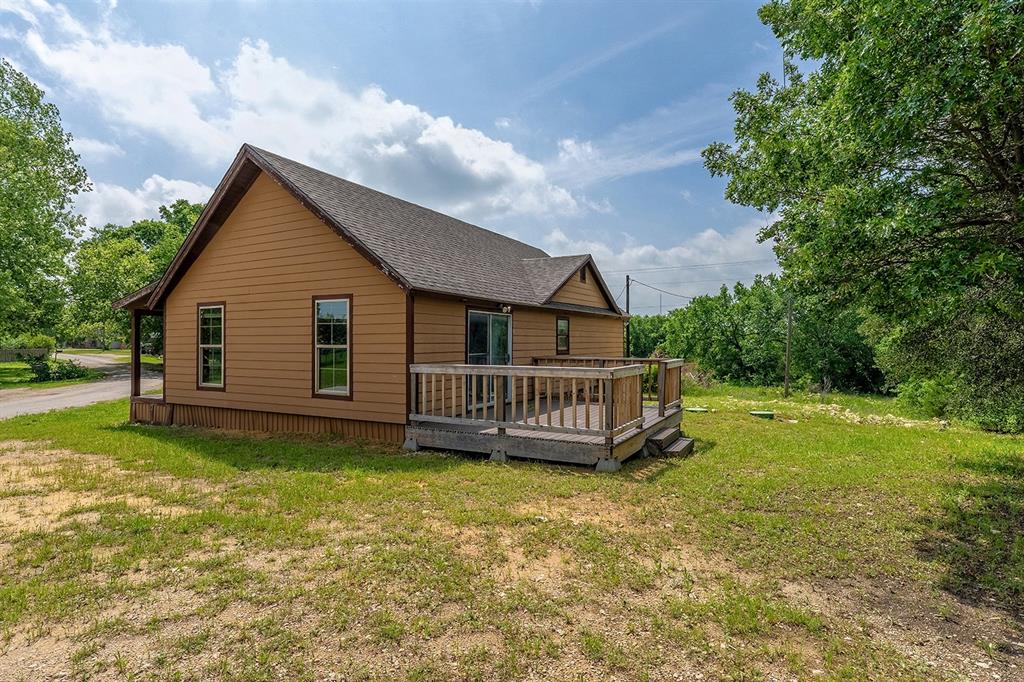 371 Spring Street Forestburg, TX 76239 - Photo 36 of 38 a view of a house with a yard and deck