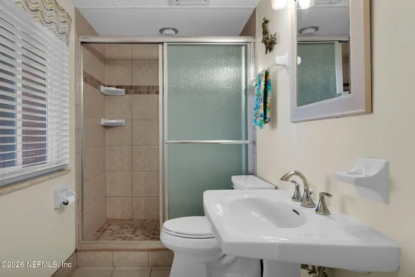 a bathroom with a sink toilet and shower