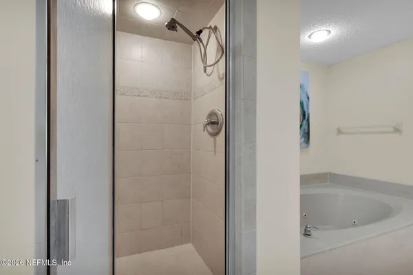 a bathroom with a tub and shower