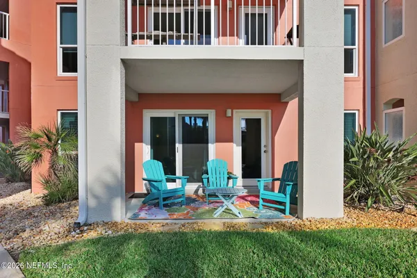 a view of front door of house with outdoor seating