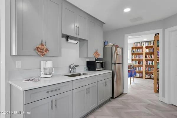 a kitchen with stainless steel appliances a refrigerator sink and cabinets