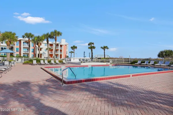 a view of swimming pool with outdoor seating and city view
