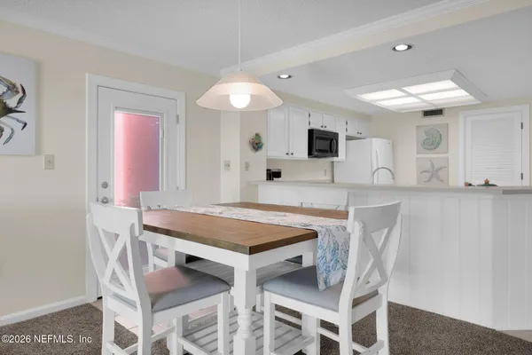 a dining room with furniture and window