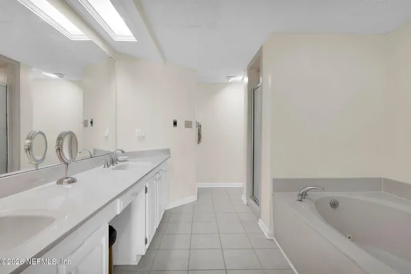a spacious bathroom with a granite countertop sink a toilet and shower