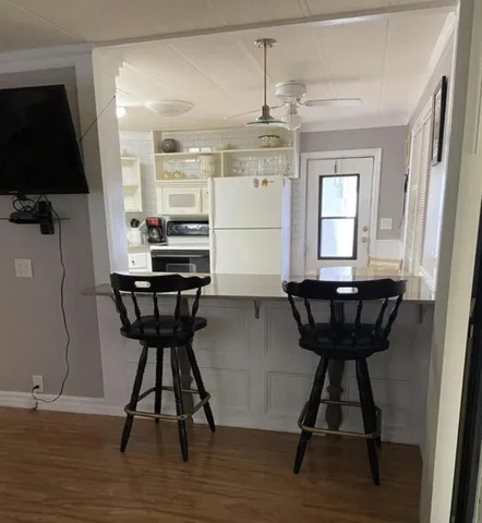 a view of a room with furniture and wooden floor