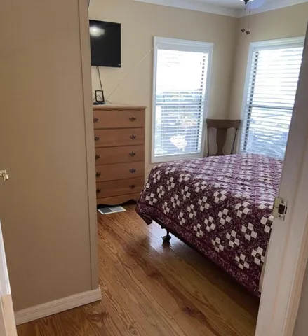 a bedroom with a bed and a flat tv screen