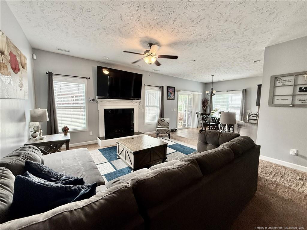 35 Ambrose Point Cameron, NC 28326 - Photo 12 of 31 a living room with furniture a fireplace and a flat screen tv