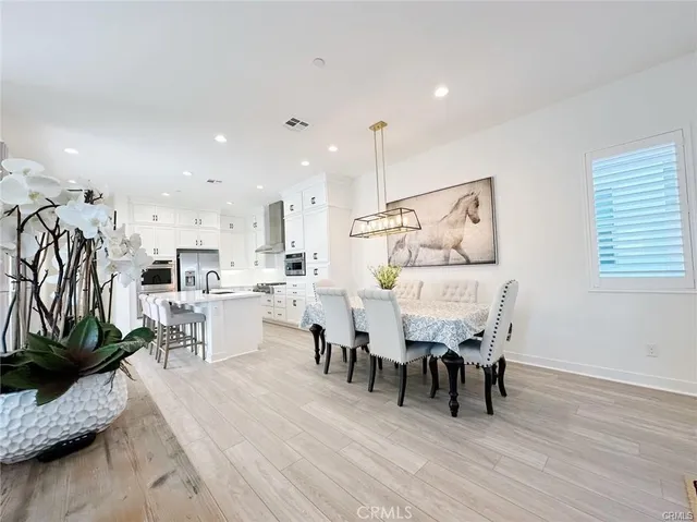 a dining room with furniture and wooden floor