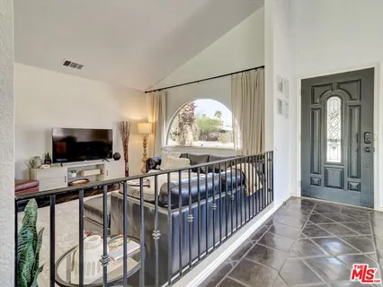 a view of a livingroom with furniture and a flat screen tv