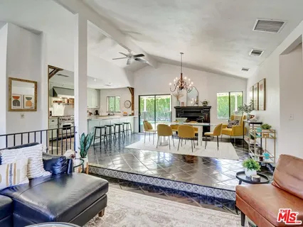 a living room with fireplace furniture or chandelier and a wooden floor