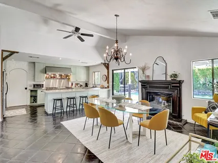 a view of a dining room with furniture and chandelier