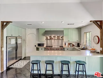 a kitchen with granite countertop a table and chairs