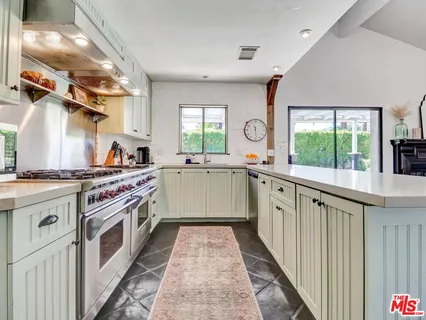 a kitchen with a sink stove and cabinets