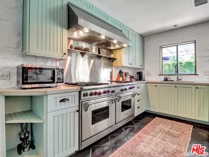 a kitchen with a stove top oven sink and cabinets