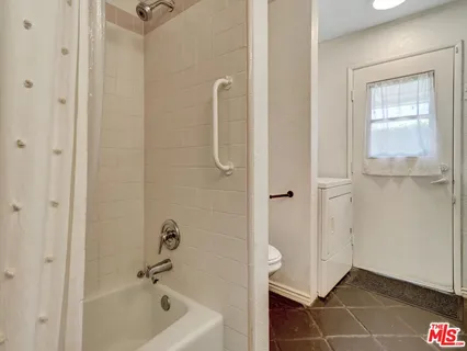 a bathroom with a bathtub and shower