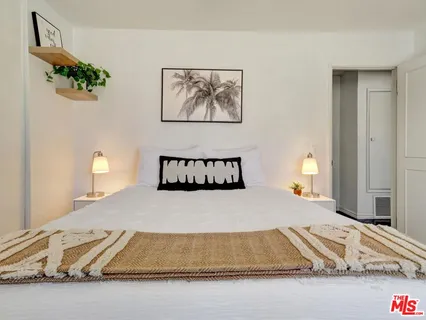 a room with a bed and a night stand