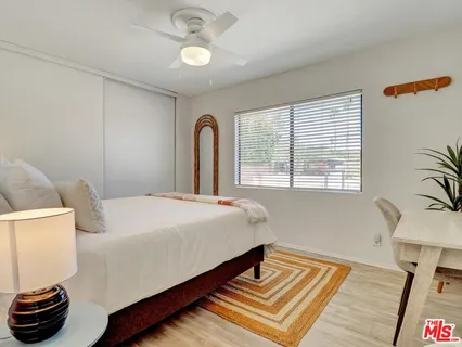 a bedroom with a bed and a window