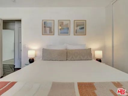 a bed room with a large bed and a lamp