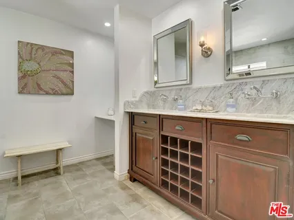a spacious bathroom with a granite countertop sink a mirror and a
