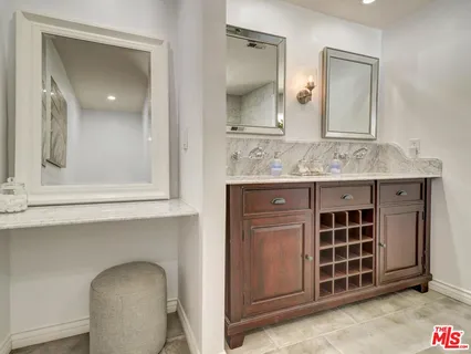 a bathroom with a granite countertop sink a mirror and a