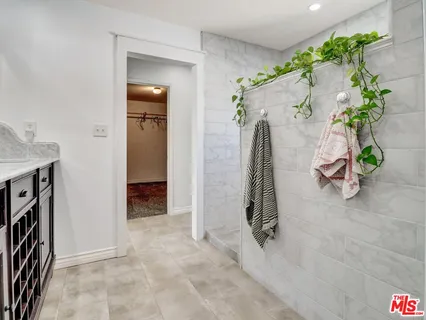 an entryway with front door and wooden floor